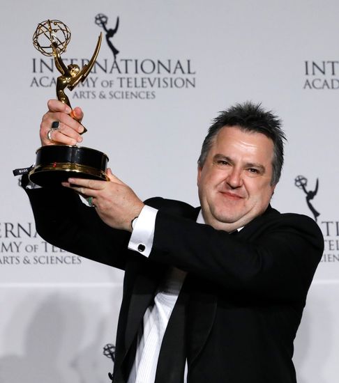 Stephen Corvini holding the International Emmy Award